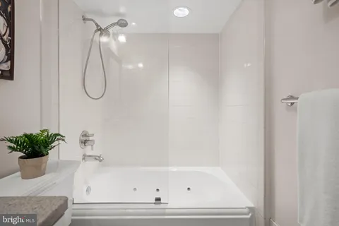a bathroom with a bath tub and shower