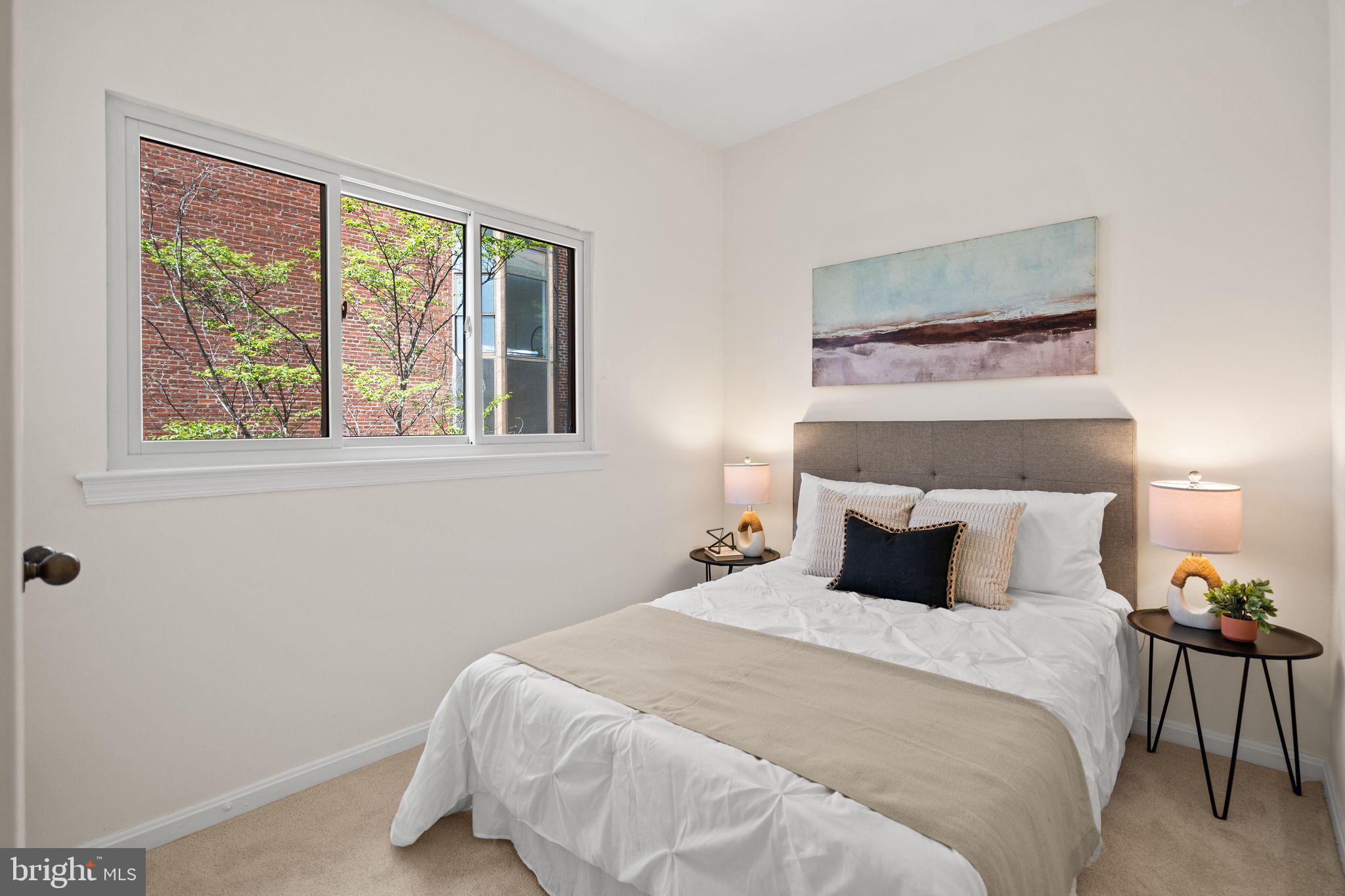 1008 Paper Mill Court, Unit 1008 Washington, DC 20007 - Photo 15 of 31 a bedroom with a bed and a window