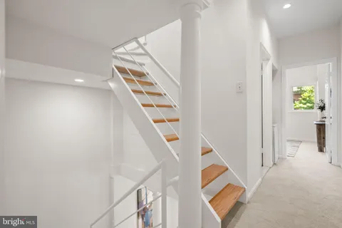 a view of stairs and hardwood floor