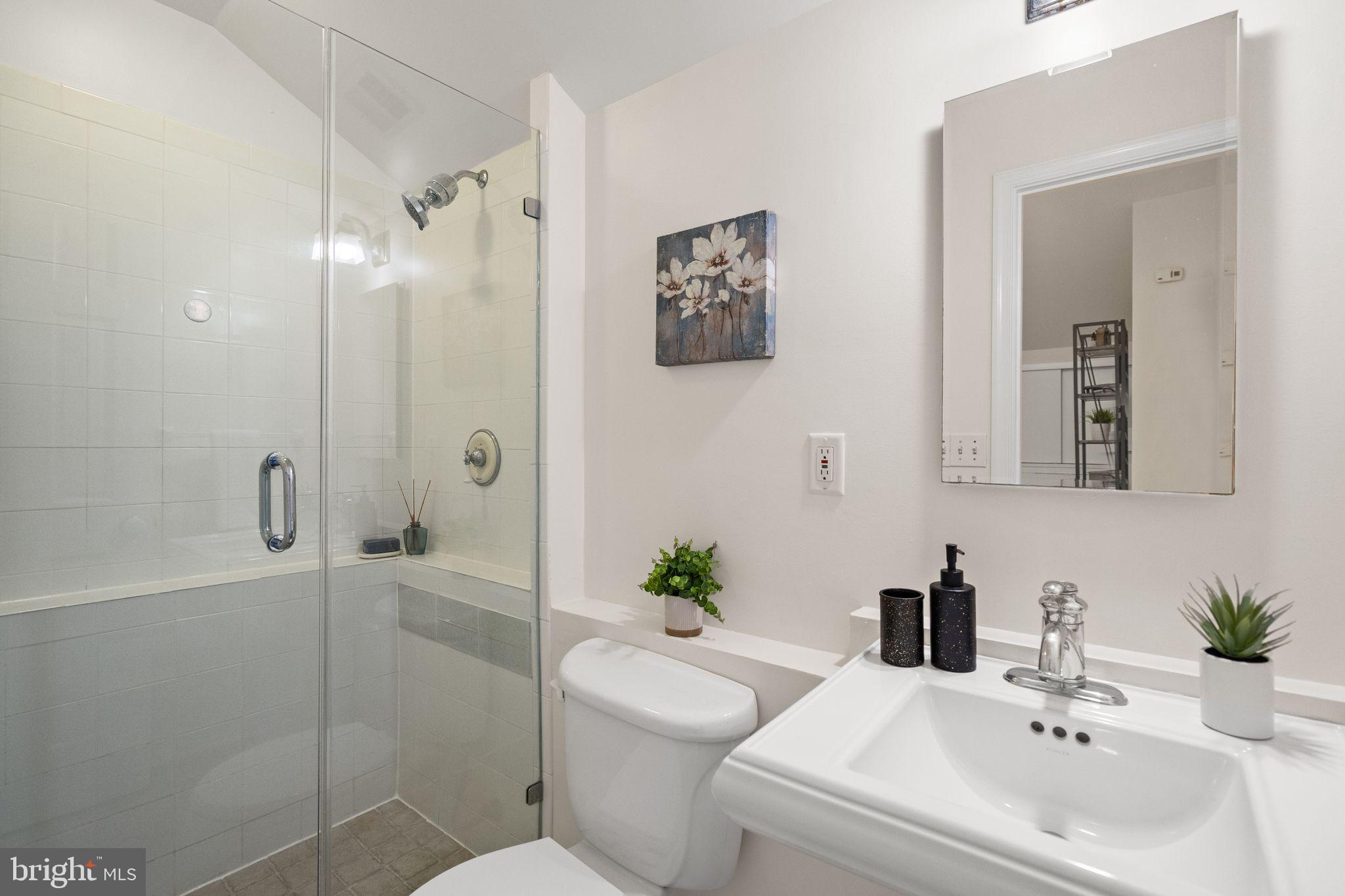 1008 Paper Mill Court, Unit 1008 Washington, DC 20007 - Photo 19 of 31 a bathroom with a sink a toilet and shower