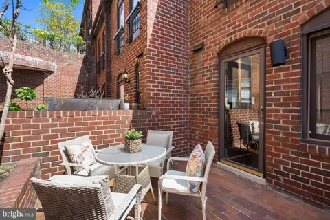 a backyard of a house with table and chairs