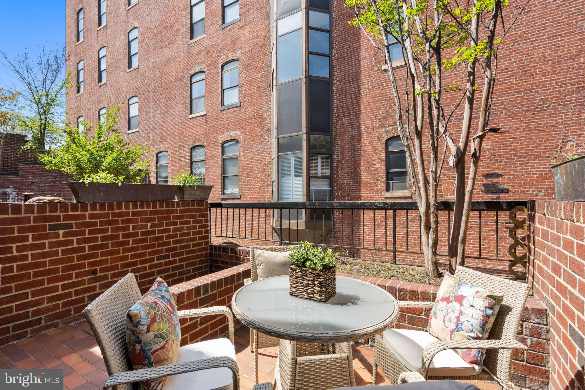 1008 Paper Mill Court, Unit 1008 Washington, DC 20007 - Photo 21 of 31 a view of a patio with couches table and chairs and potted plants