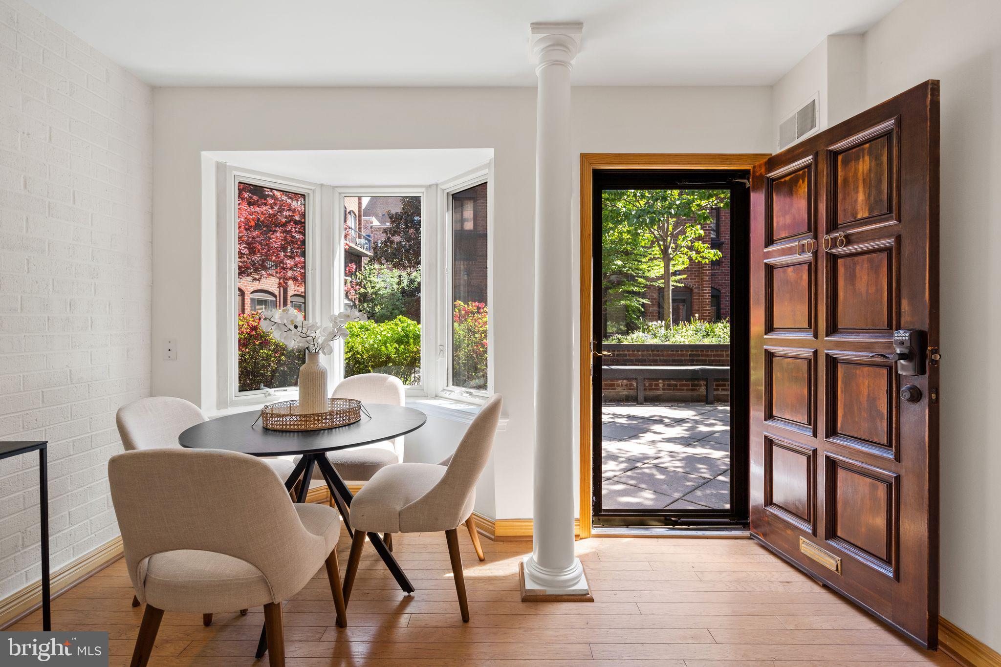 1008 Paper Mill Court, Unit 1008 Washington, DC 20007 - Photo 4 of 31 a dining room with furniture a rug wooden floor and a window