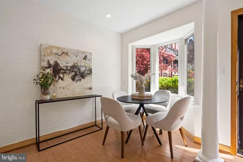 a view of a dining room with furniture and a window
