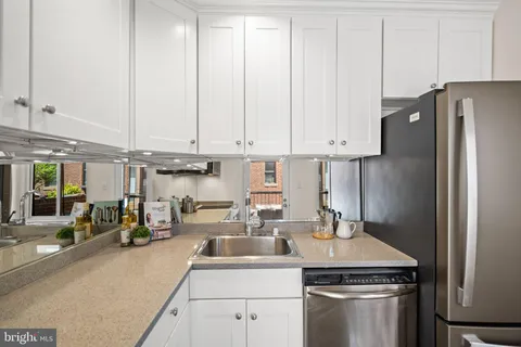 a kitchen with a sink and white cabinets