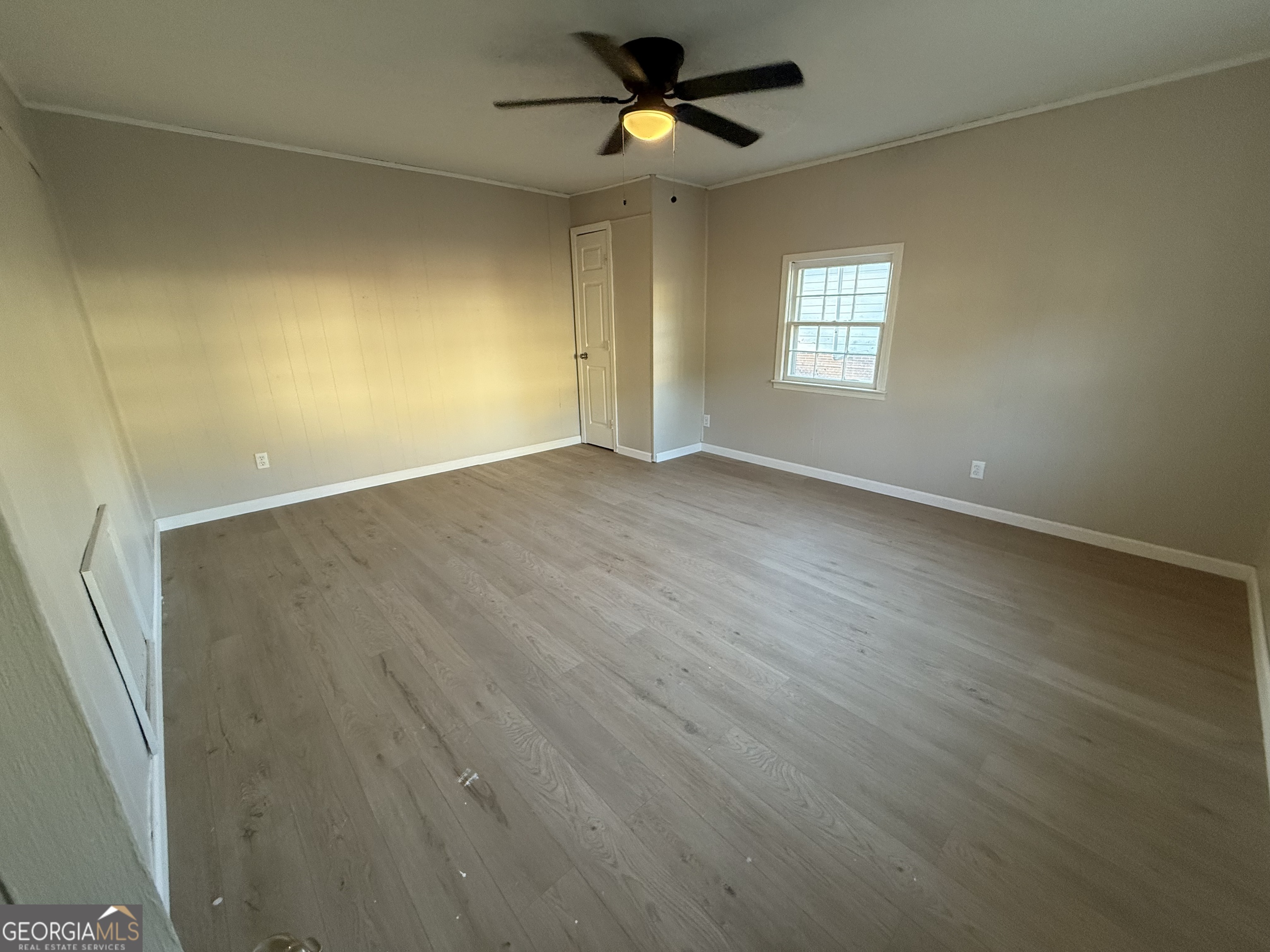 75 3rd Shannon Street Northeast Rome, GA 30161 - Photo 5 of 14 an empty room with wooden floor ceiling fan and windows