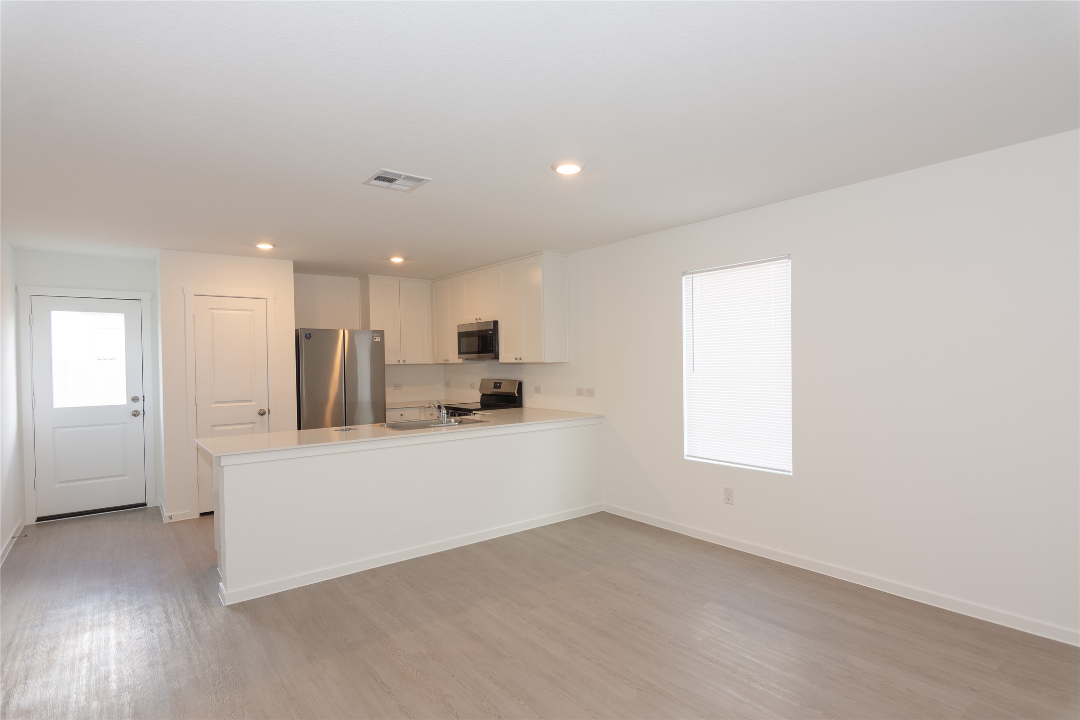 153 Star Packer Lane Jarrell, TX 76537 - Photo 6 of 30 A streamlined open-concept space features contemporary finishes and abundant natural light.