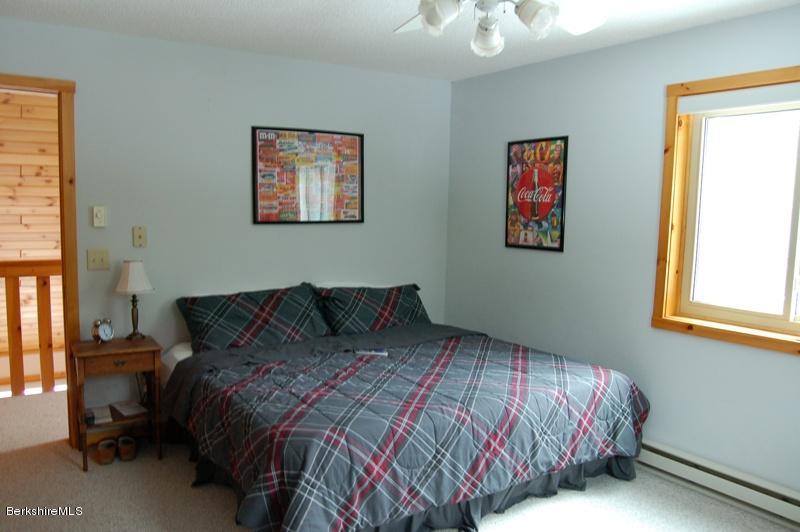 216 Dimmock Road Otis, MA 01253 - Photo 11 of 18 a bedroom with a bed and a painting on the wall