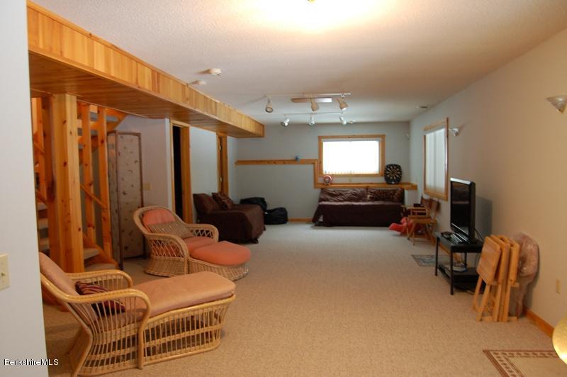 216 Dimmock Road Otis, MA 01253 - Photo 13 of 18 a living room with furniture a flat screen tv and a window