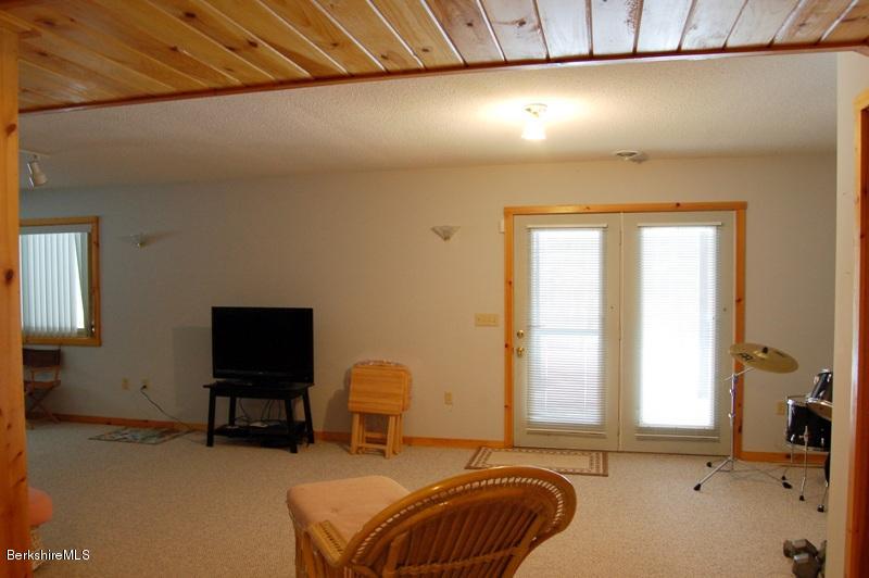 216 Dimmock Road Otis, MA 01253 - Photo 14 of 18 a bedroom with a bed and a chair