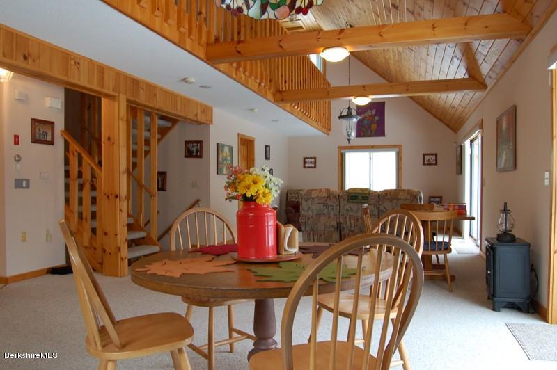216 Dimmock Road Otis, MA 01253 - Photo 6 of 18 a view of a dining room with furniture and a chandelier