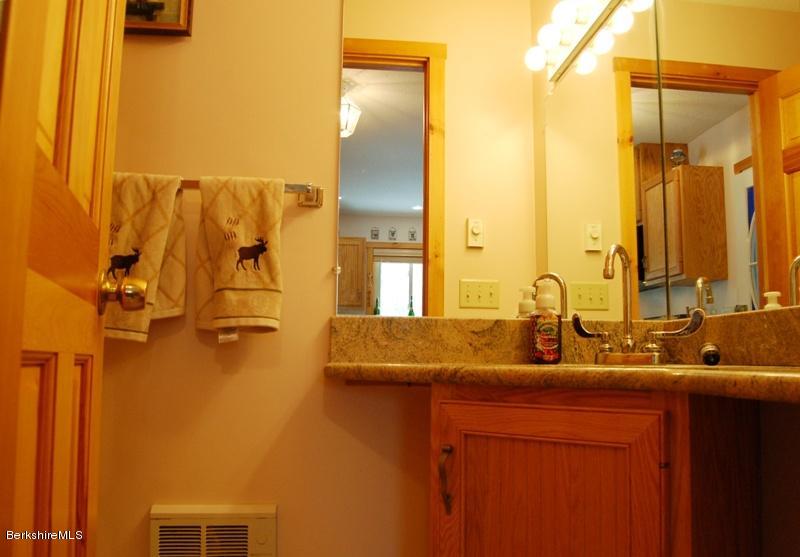 216 Dimmock Road Otis, MA 01253 - Photo 8 of 18 a bathroom with a granite countertop sink and a mirror