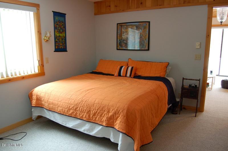 216 Dimmock Road Otis, MA 01253 - Photo 9 of 18 a bed sitting in a bedroom next to a window