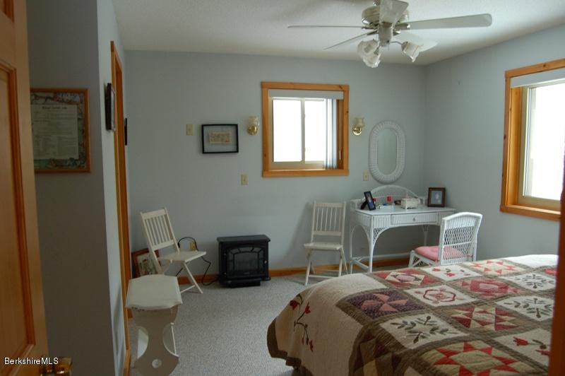 216 Dimmock Road Otis, MA 01253 - Photo 10 of 18 a bedroom with a bed a table and chair
