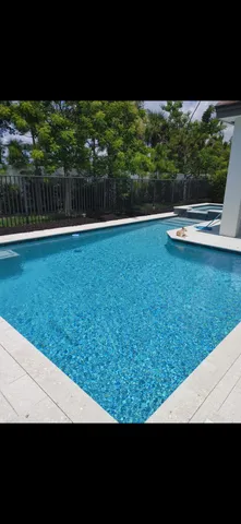 a view of a chair and tables in the patio next to a yard