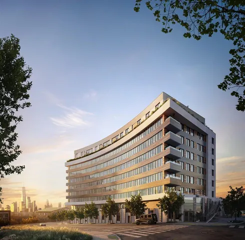 a view of a tall building next to a road