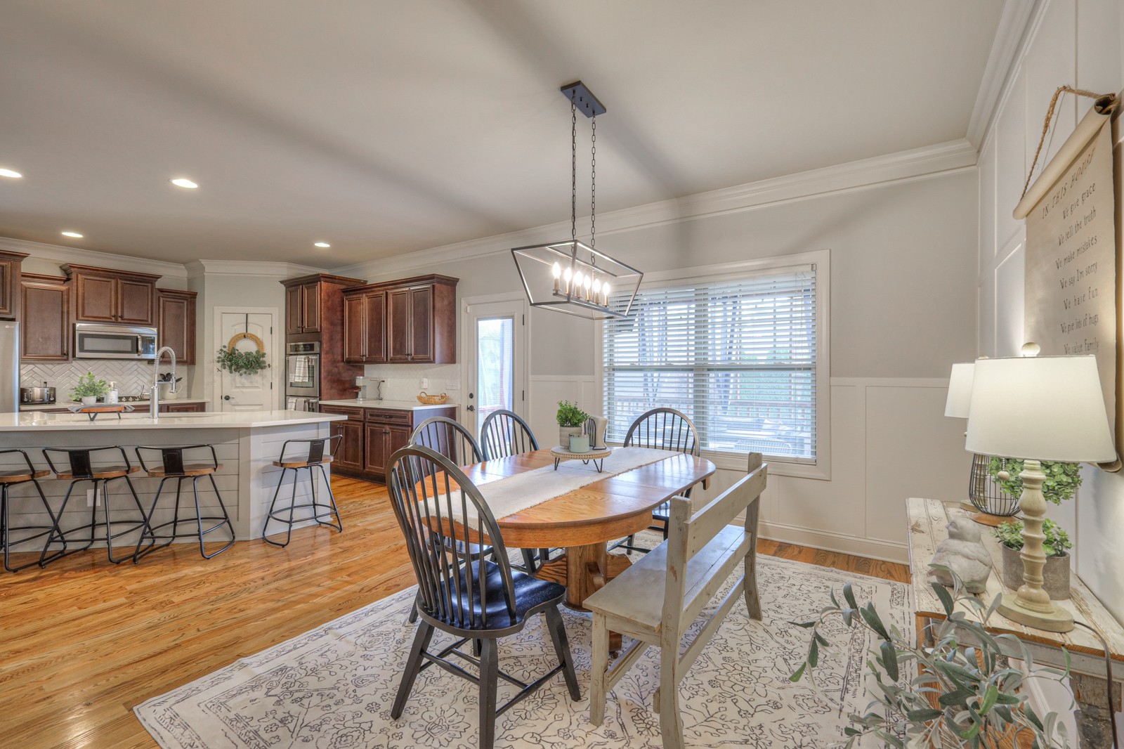 7020 Brindle Ridge Way Spring Hill, TN 37174 - Photo 12 of 42 a dining area with stainless steel appliances kitchen island granite countertop a dining table chairs and a refrigerator