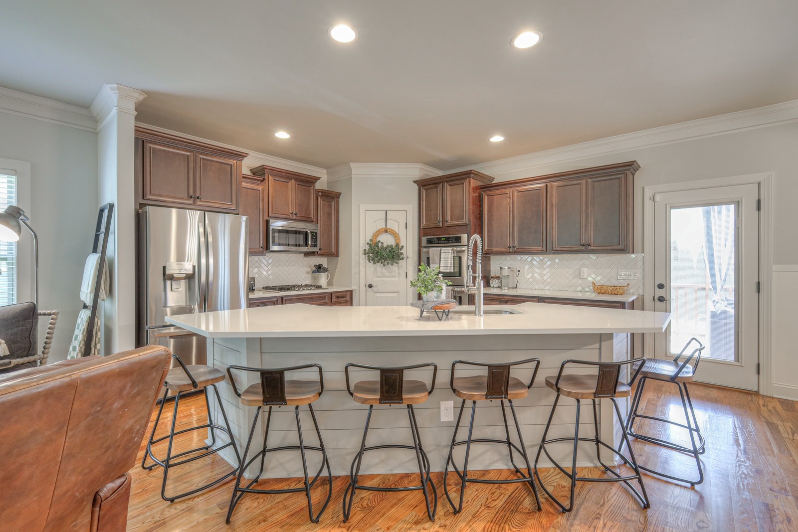7020 Brindle Ridge Way Spring Hill, TN 37174 - Photo 9 of 42 a kitchen with stainless steel appliances granite countertop a refrigerator a stove a sink a dining table and chairs