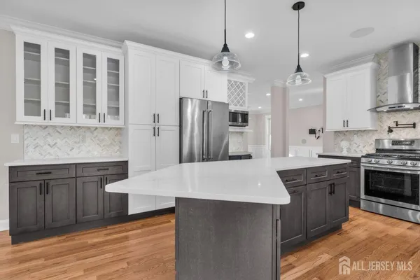 a view of granite countertop cabinets and wooden floor