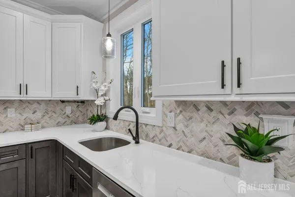 a kitchen with kitchen island a counter top space stainless steel appliances and cabinets