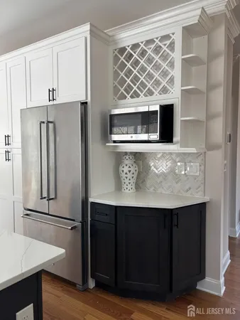 a kitchen with stainless steel appliances kitchen island wooden cabinets and refrigerator