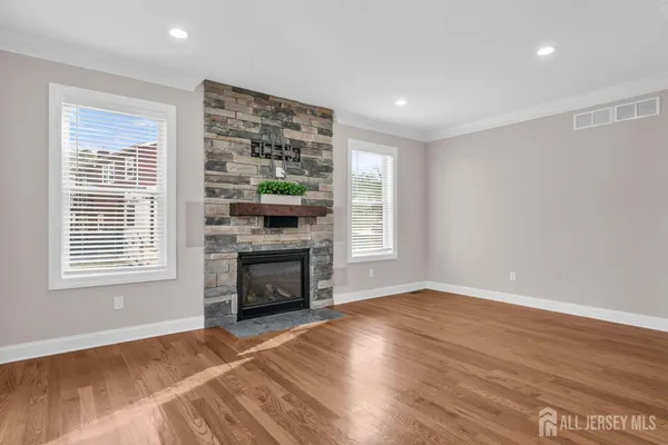 a view of front door with wooden floor and stairs