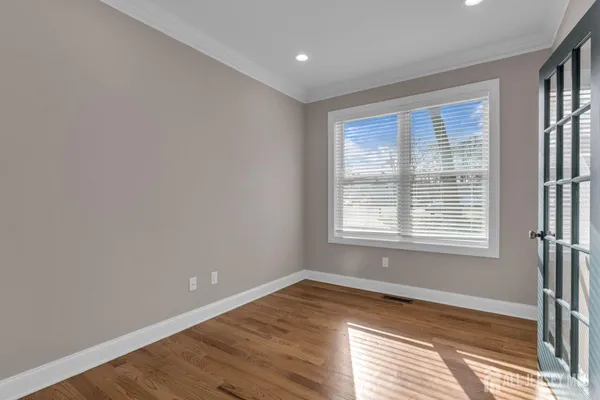 a view of a hallway with wooden floor and stairs