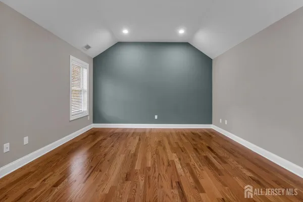 an empty room with wooden floor