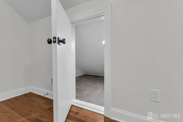 an aerial view of a house with garden space and trees