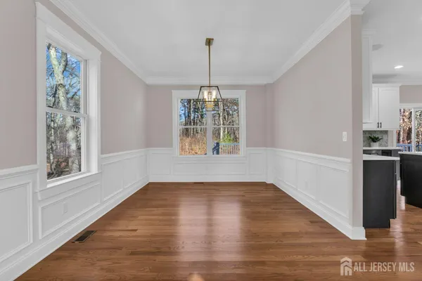 a kitchen with a sink a center island a stove and a wooden floor