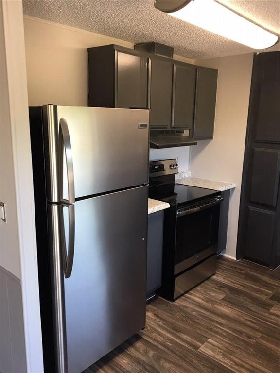 365 Darrell Road Roanoke, TX 76262 - Photo 3 of 22 Stainless steel refrigerator, black electric range, black cabinetry, light-toned countertops, and wood-finish flooring
