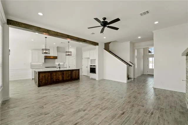 a view of workspace with wooden floor and ceiling fan