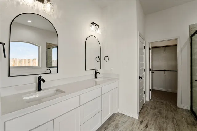 a bathroom with a double vanity sink and mirror