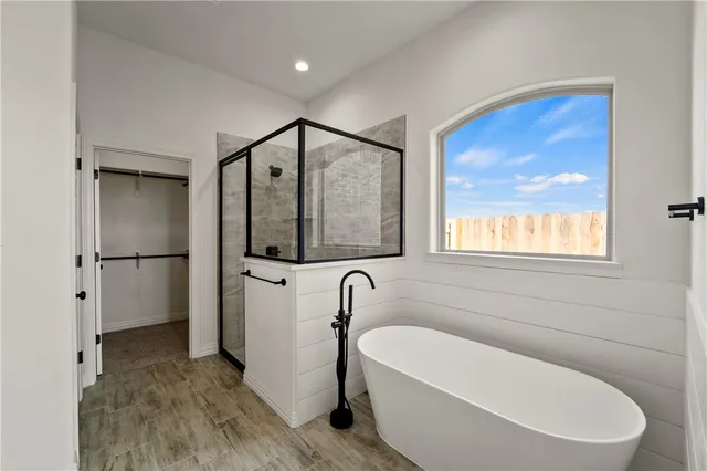 a bathroom with a bathtub and a window