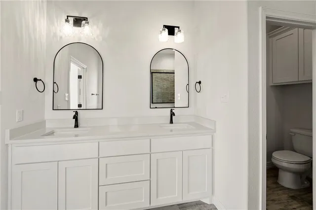 a bathroom with 2 sink and a mirror