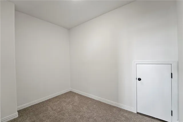 a bathroom with a granite countertop bathtub shower sink vanity mirror and toilet