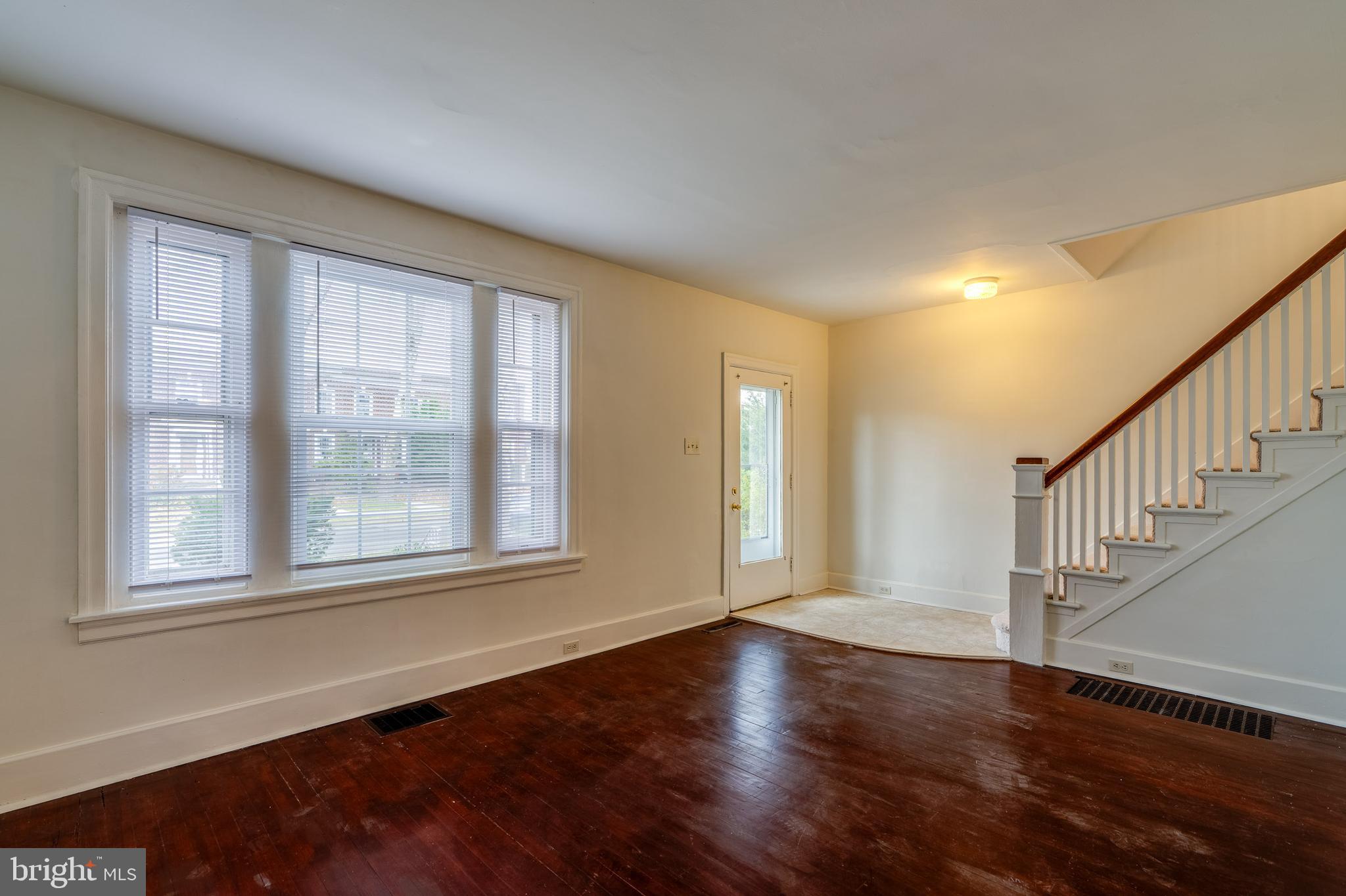 423 Sunset Road Reading, PA 19611 - Photo 14 of 39 a view of an empty room with wooden floor and a window