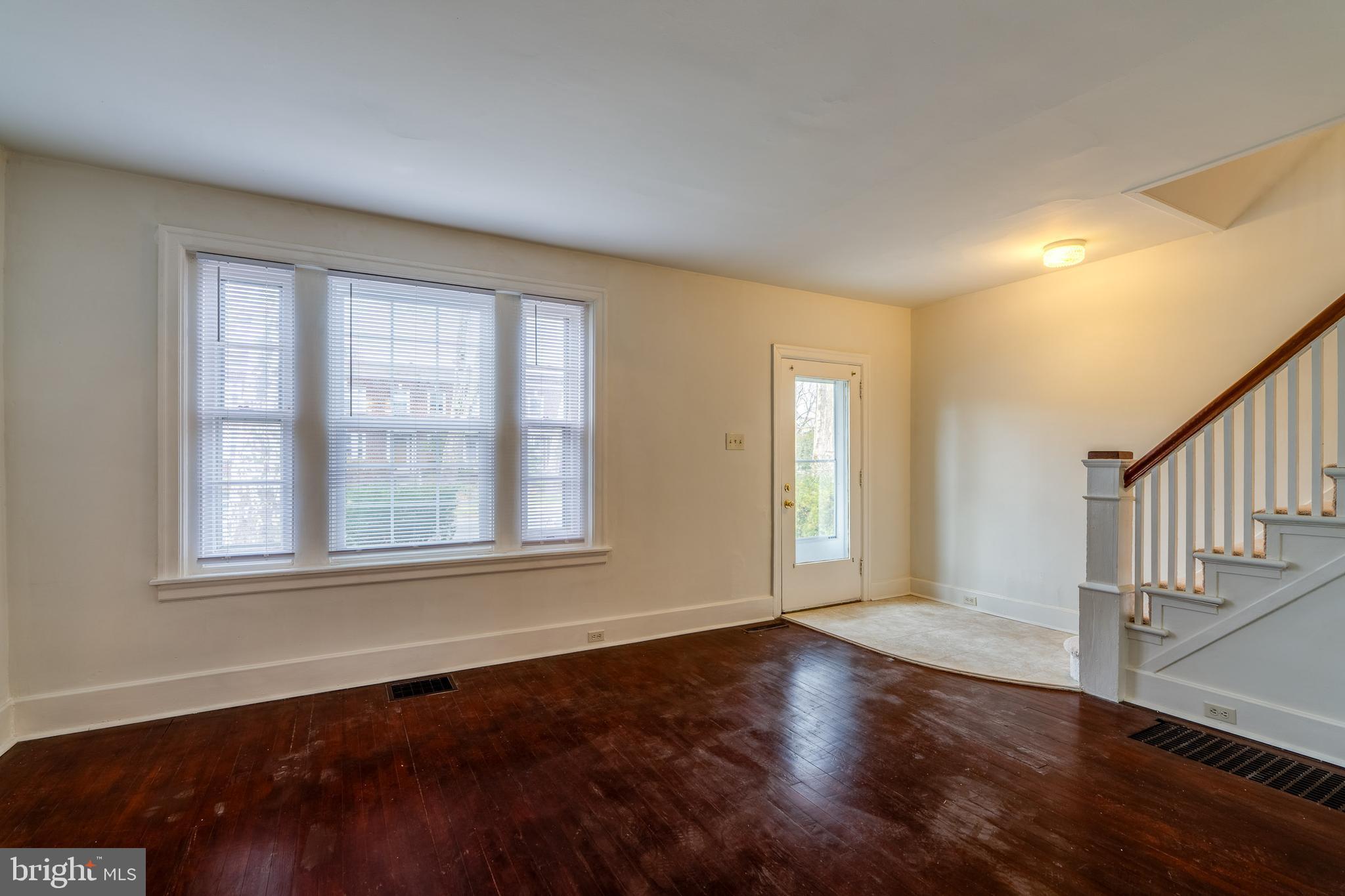 423 Sunset Road Reading, PA 19611 - Photo 15 of 39 a view of an empty room with wooden floor and a window