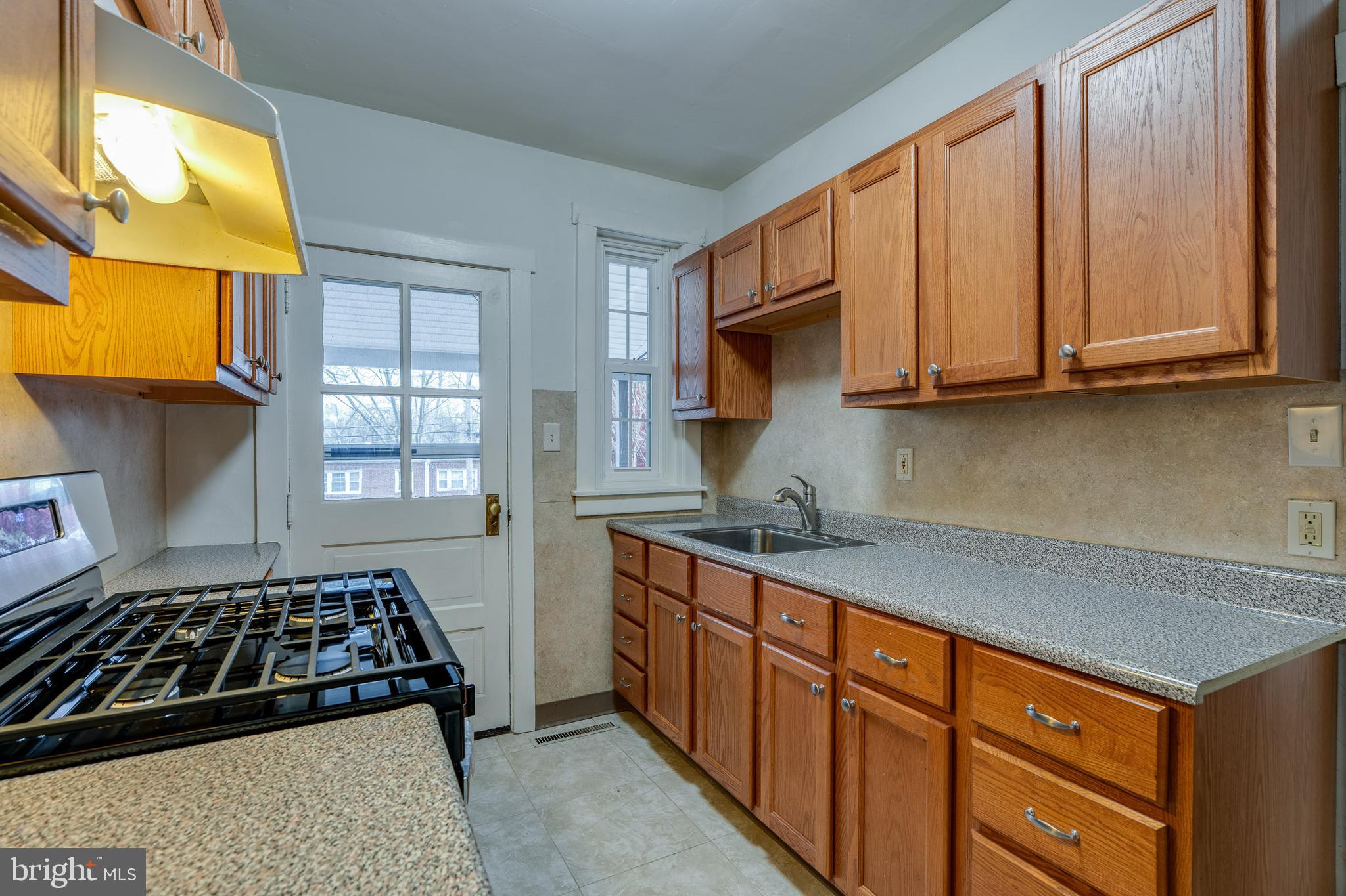 423 Sunset Road Reading, PA 19611 - Photo 19 of 39 a kitchen with stainless steel appliances granite countertop a stove a sink and a microwave