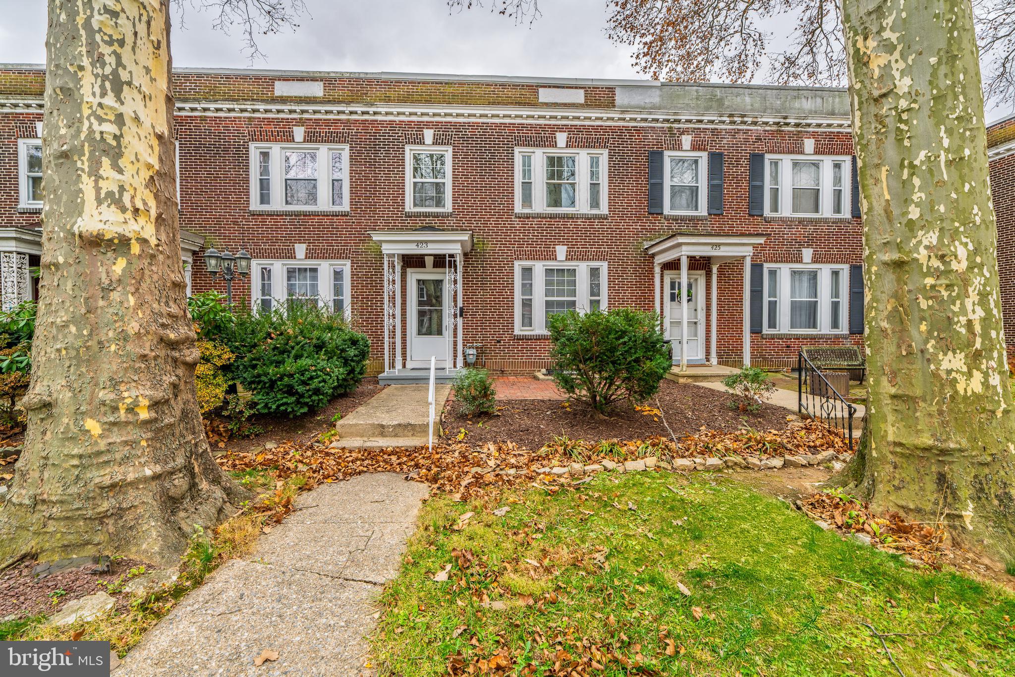 423 Sunset Road Reading, PA 19611 - Photo 2 of 39 a view of a brick house with many windows next to a yard