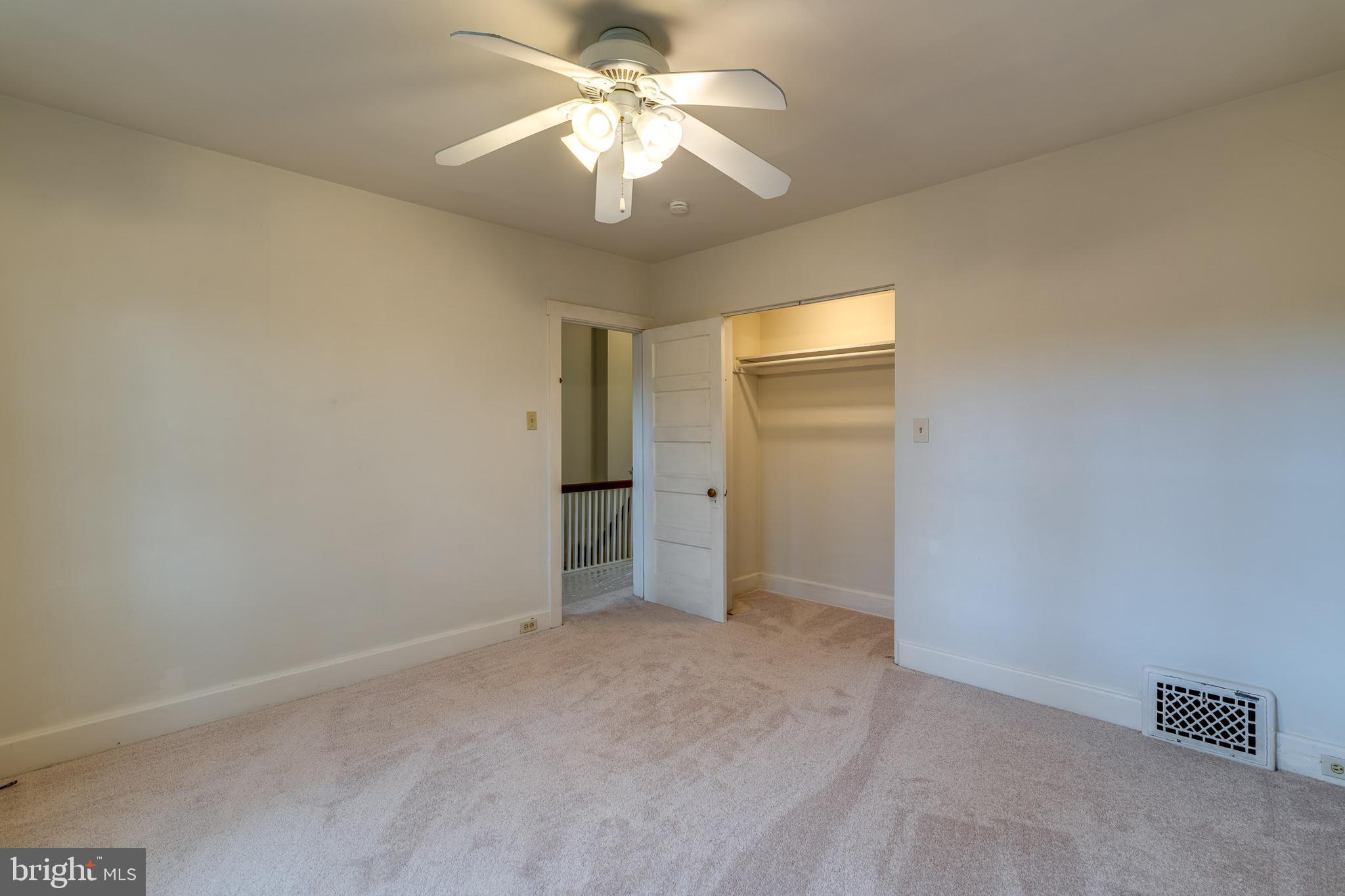 423 Sunset Road Reading, PA 19611 - Photo 29 of 39 an empty room with a chandelier fan and windows