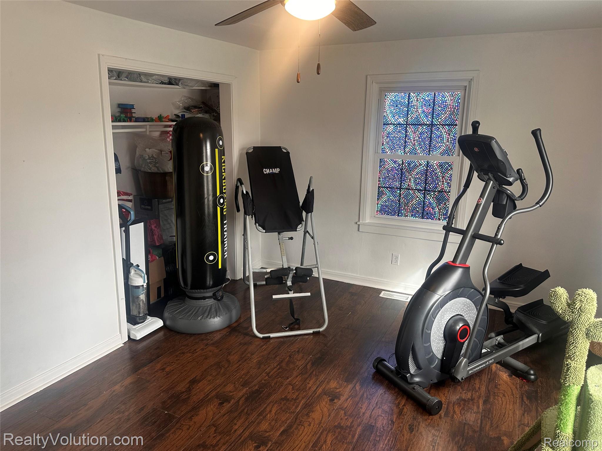 3034 West Oregon Road Lapeer, MI 48446 - Photo 14 of 29 Exercise room with dark wood finished floors and ceiling fan