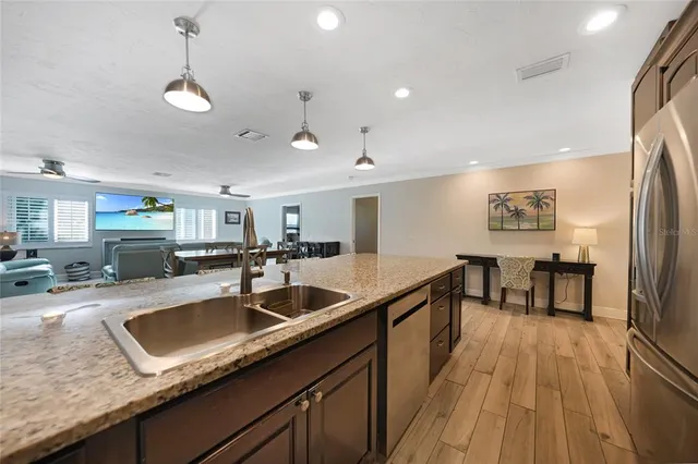 a kitchen with stainless steel appliances granite countertop a sink and a stove