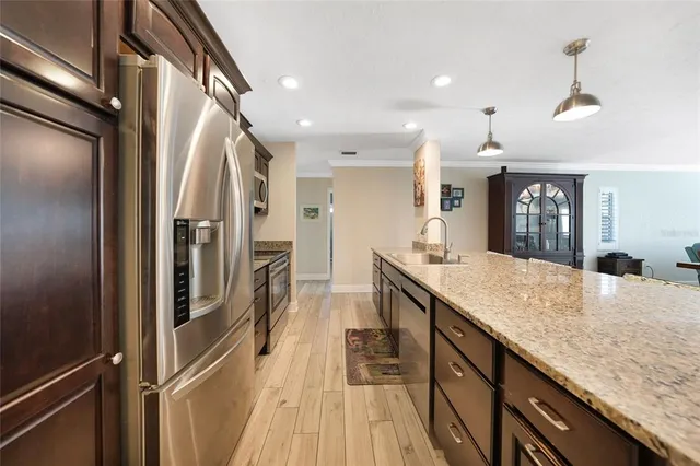a kitchen with kitchen island granite countertop a table and chairs in it