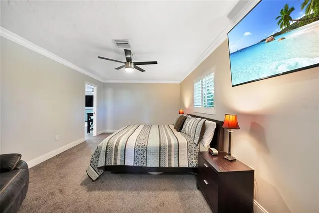 a bedroom with a bed and a painting on the wall