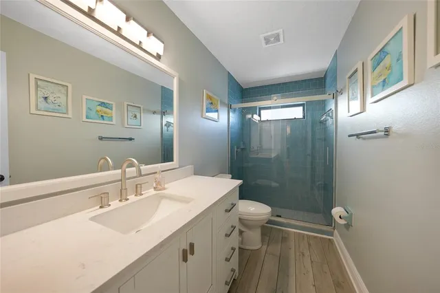 a bathroom with a sink a toilet and mirror