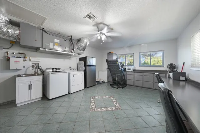 a view of a patio with table and chairs and potted plants