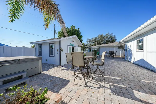 a view of patio with table and chairs and potted plants