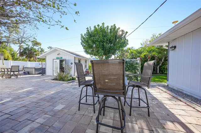 a view of house with backyard outdoor seating and trees