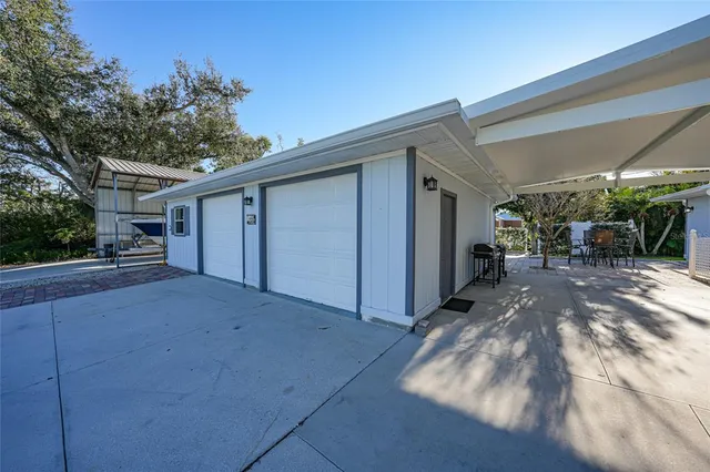a view of a house with backyard and sitting area